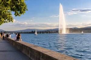 Lakeside promenade in Geneva with the Jet d'Eau at sunset
