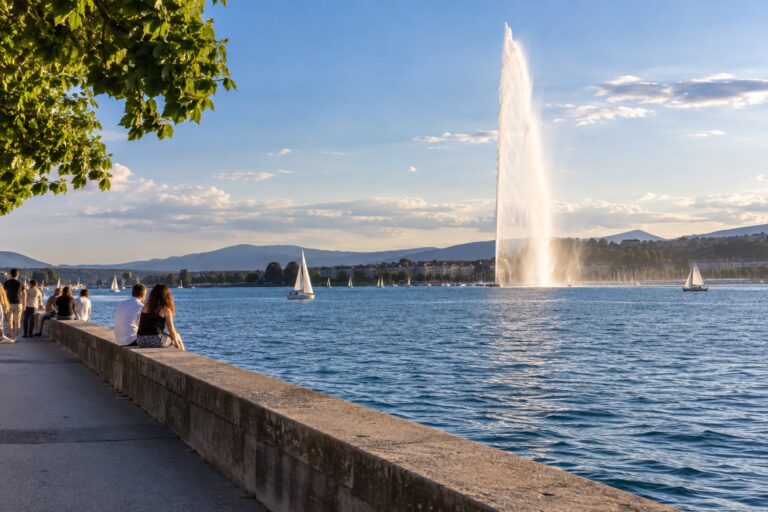 Lakeside promenade in Geneva with the Jet d'Eau at sunset